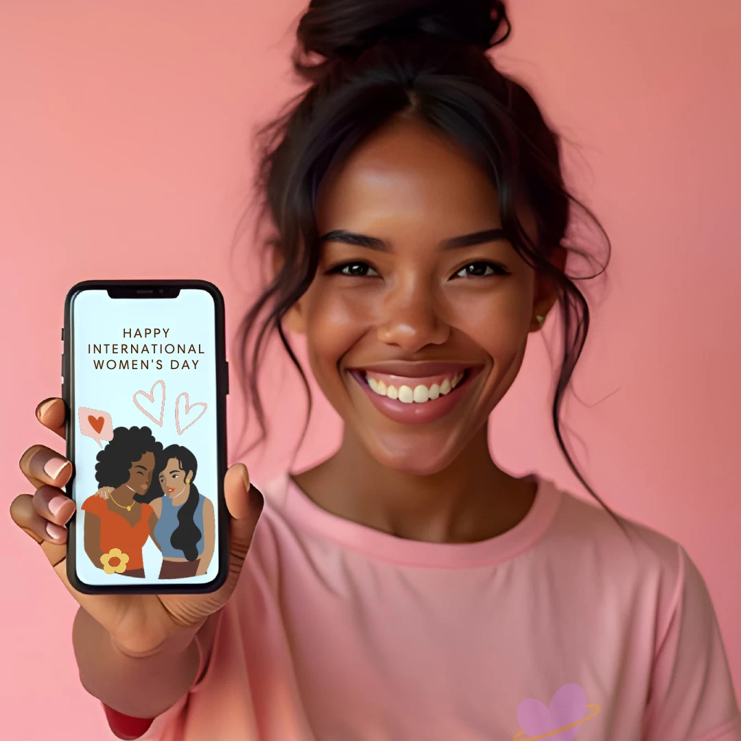 A person holding a smartphone displaying a celebratory message for International Women's Day, set against a pink background.