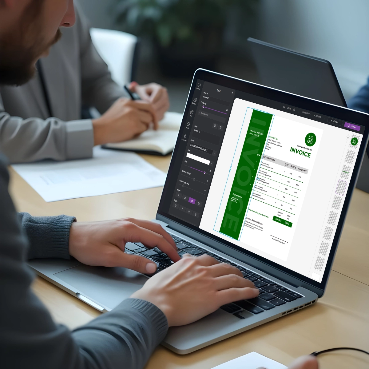 Person using laptop to edit green invoice template. Screen shows design interface with customization options. Another person writes notes nearby on desk.