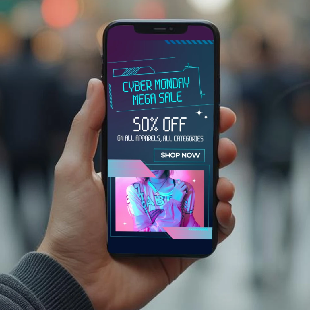 Hand holding a smartphone displaying a Cyber Monday sale ad for 50% off on apparels.